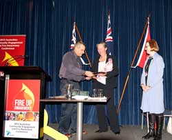 RFS Awards Our Brigade frances crown receiving the rfs award for the women's training program from rfs deputy commissioner rob rogers with carolyn chaplin (right) looking on